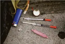  ?? ?? Syringes used to inject fentanyl are common on Willow Street, an alleyway often lined with tents where drug use is common.