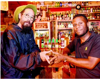  ??  ?? Lee (left) seals the deal with Dub Club’s owner, Selector Gabre Selassie.