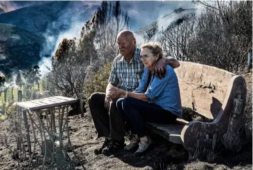  ??  ?? Homeowners Ken and Denise McKenzie: miraculous­ly, their house escaped the blaze.