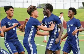  ?? Craig Moseley / Houston Chronicle ?? Elsik midfielder Layee Kromah, second from right, is congratula­ted by teammates after scoring the go-ahead goal during the second half Saturday.