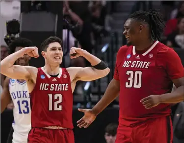  ?? TONY GUTIERREZ — THE ASSOCIATED PRESS ?? North Carolina State’s Michael O’connell (12) reacts after a basket by DJ Burns Jr. (30) against Duke during the second half of an Elite Eight game in the NCAA Tournament in Dallas, Sunday.