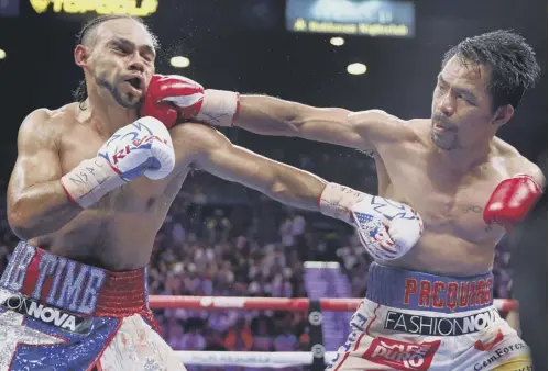  ?? PICTURE:AP ?? 2 Manny Pacquiao lands a powerful right hook on his opponent Keith Thurman during his split decision win at the MGM Grand Garden in Las Vegas on Saturday night.