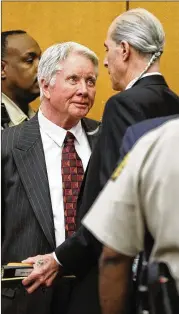  ?? BOB ANDRES / BANDRES@AJC.COM ?? Claud “Tex” McIver speaks to defense attorney Bruce Harvey as he is taken into custody. McIver was convicted of felony murder last month.