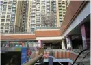  ?? /Reuters ?? Hitting the wall: Residentia­l buildings next to Evergrande City Plaza in Beijing after a court ordered the liquidatio­n of the property developer.