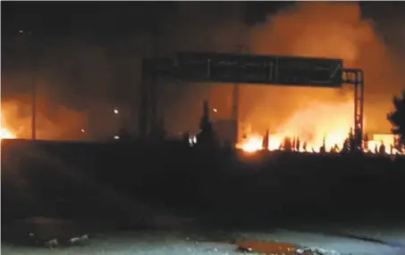  ?? Syrian Arab News Agency ?? Flames rise after an attack on an area known to have numerous army military bases, in Kisweh, south of Damascus.