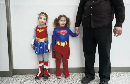  ??  ?? Five-year-olds Talia (left) and Miranda Winnig of San Jose join the cosplay in their superhero roles Saturday at Comic Con.