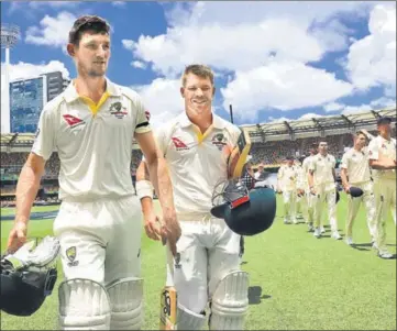  ?? REUTERS ?? Cameron Bancroft (left) and David Warner walk off after Australia’s 10wicket win on Monday.