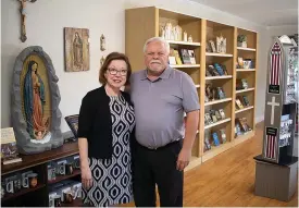  ?? Gazette photo by Sara Vaughn ?? ■ Mike and Carolyn Lee recently opened Divine Will Catholic Art Books and Gifts at 720 Arkansas Blvd., a shop that sells books, art and gifts pertaining to the Catholic faith.