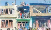  ?? PTI ?? People inspect a damaged house where four militants and a soldier were killed during an encounter at Shopian on Tuesday.