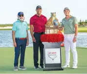  ?? ?? Viktor Hovland (right) poses with the Hero World Challenge trophy alongside legendary golfer Tiger Woods (centre) and Pawan Munjal, Chairman & CEO of Hero MotoCorp, in Albany, Bahamas, on Sunday.