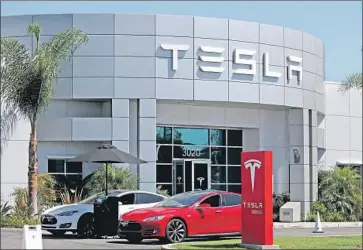  ?? Allen J. Schaben Los Angeles Times ?? THE STATE’S plan to boost electric vehicle subsidies by $2,000 comes as customers of Tesla Inc. and General Motors Co. face the loss of a $7,500 federal tax credit. Above, a Tesla service facility in Costa Mesa.