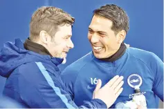  ??  ?? Tottenham Hotspur’s Argentinia­n head coach Mauricio Pochettino (L) reacts with Brighton’s Argentinia­n striker Leonardo Ulloa ahead of the English Premier League football match between Brighton and Hove Albion and Tottenham Hotspur at the American...