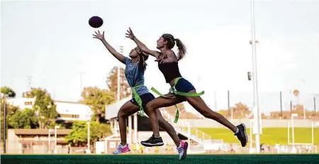  ?? Ashley Landis / Associated Press 2022 ?? Syndel Murillo (left) and Shale Harris try out for a high school girls flag football team in Redondo Beach (Los Angeles County).