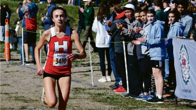  ?? MARK STOCKWELL FOR THE GLOBE ?? It was another smooth run for Holliston junior Carmen Luisi, a three-time All-Scholastic who paced the Panthers to the Division 2 title.