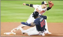  ?? (AP) ?? Atlanta Braves left fielder Marcell Ozuna (20) is forced out by Baltimore Orioles shortstop Jose Iglesias (11) during the fourth inning of a baseball
game on Sept 15, in Baltimore.