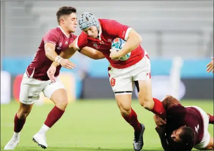  ??  ?? Wales’ Jonathan Davies runs at the Georgia defence during the Rugby World Cup Pool D game between Wales and Georgia at Toyota City Stadium,
Toyota City, Japan on Sept 23. (AP)