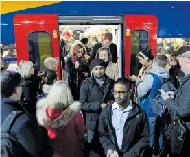  ??  ?? Standing on overcrowde­d trains is a daily reality for many commuters