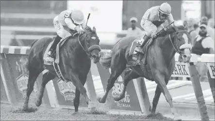  ?? Peter Foley European Pressphoto Agency ?? UNION RAGS,
right, overtakes Paynter to win the Belmont Stakes. Union Rags is trained by Michael Matz, who had saddled Barbaro.