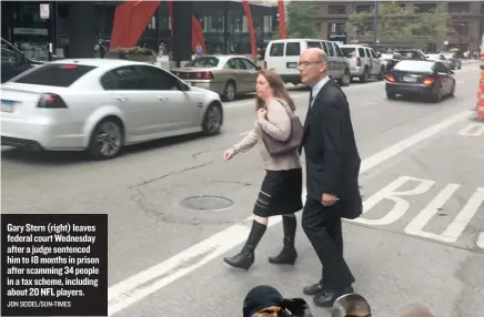  ?? JON SEIDEL/ SUN- TIMES ?? Gary Stern ( right) leaves federal court Wednesday after a judge sentenced him to 18 months in prison after scamming 34 people in a tax scheme, including about 20 NFL players.