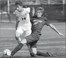  ?? SARAH GORDON/THE DAY ?? In this Oct. 2, 2019, file photo, East Lyme’s Finn Power (10) and Waterford’s Colin Palazzo (14) struggle for the ball during a boy’s soccer game at East Lyme High School.