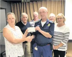  ??  ?? Derek Windybank, of the WLCFR group, receiving the cheque for £900 from Linda Barratt, BGC chairman. In the background are some members of the show committee, from left, Trevor Allcoat, Bob Gwynn (show manager), Derek Wheeler and Anne Brett. Other members who were unable to attend were Caroline Wood, Pat Wood and Nick Miles