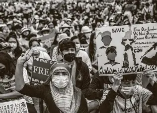  ?? New York Times ?? People in Yangon, Myanmar, protest the nation’s recent military coup. The protesters’ threefinge­r gesture, a widely used sign of civil disobedien­ce, is adapted from “The Hunger Games.”