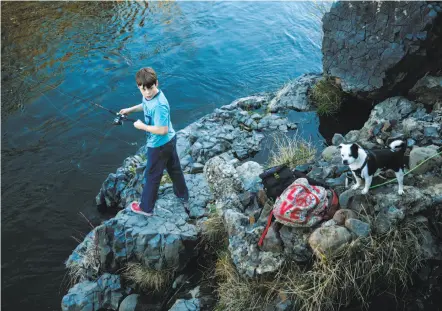  ??  ?? Top: Sophie Podeswik and Jessica Godbout enjoy the view at Monkey Face in Bidwell Park in Chico. Above: Liam Rielly, 13, fishes with his dog on the Big Chico Creek in the park. At 3,670 acres, Bidwell is by most estimates the ninth-largest city park in...