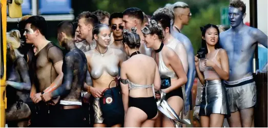  ??  ?? Raunchy: Many revellers, boys and girls alike, are topless as they head to the bash. Below and right, students dare to bare
