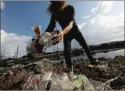  ?? Genaro Molina Los Angeles Times ?? A VOLUNTEER collects trash and debris along Ballona Creek in Marina del Rey after a rainstorm.