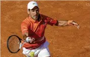  ?? ASSOCIATED PRESS ?? Novak Djokovic returns to Aslan Karatsev during their opening-round match at the Italian Open in Rome on Tuesday won by Djokovic in straight sets.