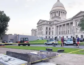  ?? JILL ZEMAN BLEED/ASSOCIATED PRESS ?? The new Ten Commandmen­ts monument outside the state Capitol in Little Rock, Ark., is blocked off Wednesday morning, after someone crashed into it with a vehicle.