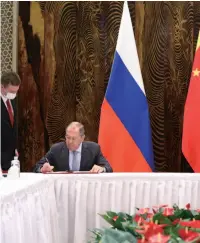  ??  ?? Russian Foreign Minister Sergey Lavrov (left) and Chinese Foreign Minister Wang Yi sign joint documents following a meeting, Guilin, capital of Southwest China’s Guangxi Zhuang Autonomous Region, March 23, 2021