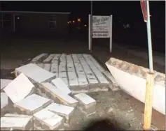  ??  ?? Concretebl­ock walls at the entrance to the King Lane apartments on Weston Street blew over when a strong, straight-line wind hit Pea Ridge after dark Saturday.