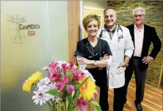  ?? PETER HVIZDAK - NEW HAVEN REGISTER ?? Janine Koukos, CareMEDICA Elite executive clinical coordinato­r, Dr. Fausto Petruzziel­lo, director of medical services, and George Kulp, director of membership services, left to right, at the CareMEDICA Elite Hamden office. CareMEDICA Elite patients...