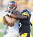  ?? KEITH SRAKOCIC/AP ?? Steelers rookie linebacker Devin Bush tackles Buccaneers tight end Tanner Hudson during Friday’s preseason game in Pittsburgh.