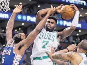  ?? ELISE AMENDOLA/ASSOCIATED PRESS ?? Boston guard Jaylen Brown (7) pulls down a rebound over Philadelph­ia’s Amir Johnson (5) during the first quarter of their game Thursday night. The Celtics rallied from a 22-point deficit.