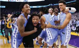  ?? Photograph: Jamie Schwaberow/NCAA Photos/Getty Images ?? Members of the North Carolina Tar Heels celebrate their win over the Duke Blue Devils in Saturday’s national semi-final in New Orleans.