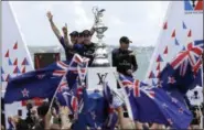  ?? GREGORY BULL — ASSOCIATED PRESS ?? Emirates Team New Zealand helmsman Peter Burling and Glenn Ashby, right, celebrate with teammates after winning the America’s Cup June 26 in Hamilton, Bermuda.