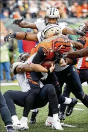  ?? JOE ROBBINS / GETTY IMAGES ?? Bengals quarterbac­k Andy Dalton is sacked Sunday at Cincinnati’s Paul Brown Stadium by New Orleans Saints Alex Okafor and David Onyemata.