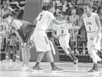  ?? Michael Wyke ?? While Sam Houston’s Torron Mingo (3) and Kendric Davis are overjoyed at advancing, Cy Falls’ Andrew Nguyen, left, has to deal with a difficult end to the season for the defending 6A champs.