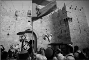  ?? ASSOCIATED PRESS ?? ISRAELIS WAVE NATIONAL FLAGS outside the Old City’s Damascus Gate in Jerusalem on Sunday. Israel is marking the 51st anniversar­y of its capture of east Jerusalem in the 1967 Middle East war.