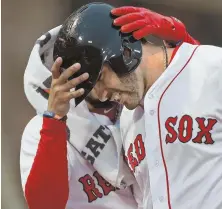  ?? STaff phoTo By MaTT SToNE ?? RED HOT: J.D. Martinez gets congratula­tions from Red Sox teammate Mookie Betts after belting a two-run home run in the first inning last night at Fenway Park.