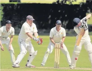  ??  ?? Waiting game: The Sonning fielders surround Aldershot tail-ender Duncan Anslow, who did his best to frustrate them with a battling 25, which, in the end, proved insufficie­nt PICTURE: PETE GARDNER