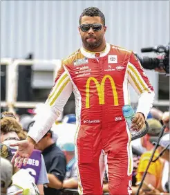  ?? SKIP ROWLAND/ASSOCIATED PRESS ?? Bubba Wallace interacts with fans during driver introducti­ons ahead of NASCAR’S Cup Series race in Richmond, Va., last month. Wallace has a tenuous hold on the 16th and final playoff spot.