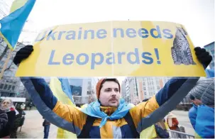  ?? (Johanna Geron/Reuters) ?? A PROTESTER HOLDS a placard in support of Ukraine during a meeting of EU foreign ministers in Brussels yesterday.