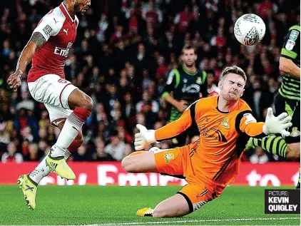  ?? PICTURE: KEVIN QUIGLEY ?? Firing Gunner: Theo Walcott taps past Doncaster’s Ian Lawlor to put Arsenal ahead in the first half