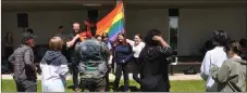  ?? ?? SCCHS student and QSA member Kylie Dyke places the Pride flag on a stand at the start of the ceremony, June 3.