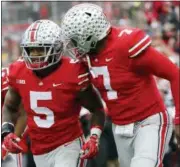  ?? JAY LAPRETE — THE ASSOCIATED PRESS ?? Ohio State running back Mike Weber, left, celebrates his touchdown against Michigan with teammate quarterbac­k Dwayne Haskins during the second half of an NCAA college football game Saturday in Columbus, Ohio. Ohio State beat Michigan 62-39.