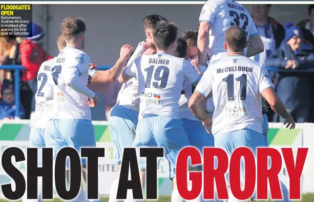  ??  ?? FLOODGATES OPEN Ballymena’s Andrew Mcgrory is mobbed after scoring his first goal on Saturday