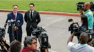  ?? Godofredo A. Vásquez / Staff photograph­er ?? Attorney Michael Elliott, left, talks to the media Friday morning before Victor Hugo Cuevas, 26, returned to court for a bond revocation hearing on a separate murder charge.